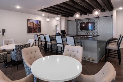 Bright common area with seating and a bar