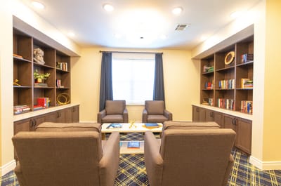 Cozy common area with bookshelves and seating