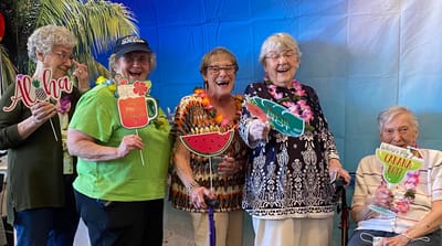 Residents celebrating with props at a themed event