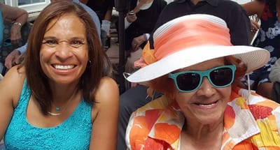 Two women smiling at an outdoor celebration