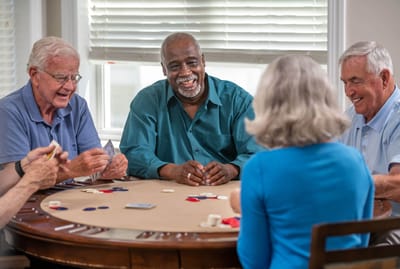 Residents enjoying a card game in an activity room