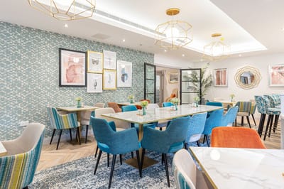 Bright dining area with colorful chairs and decor