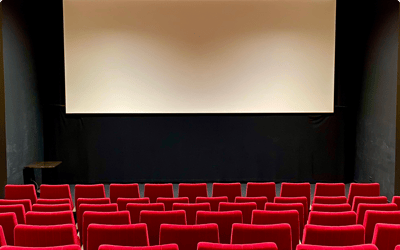 Empty cinema seating with a blank screen