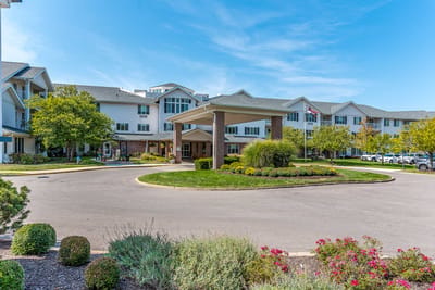 Exterior view of Solstice Senior Living with landscaped gardens and entrance