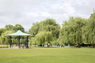 Park area with willow trees and a gazebo