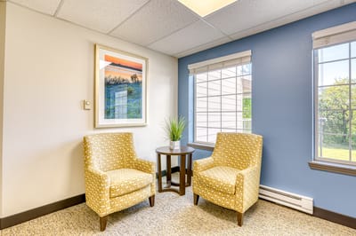 Cozy lounge area with two chairs and artwork