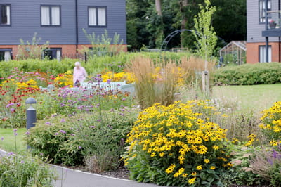 Resident enjoying the gardens at Woodbank Apartments.