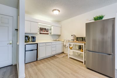 Bright kitchen area with appliances and countertop