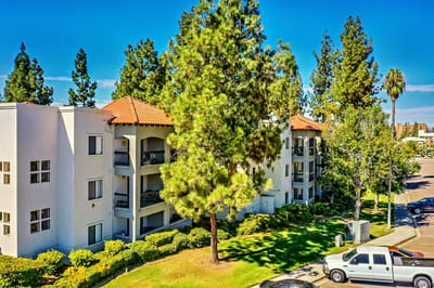 Exterior view of the senior living facility surrounded by trees