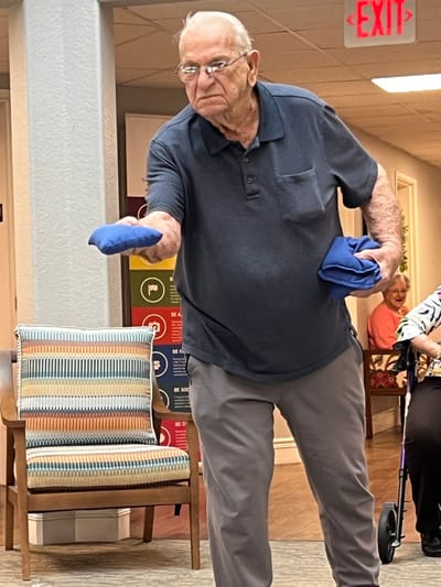 An elderly man participating in an indoor activity