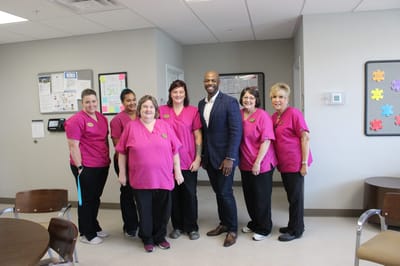 Staff members posing together in a common area