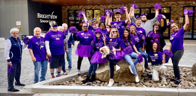 Residents and staff celebrating outside the facility
