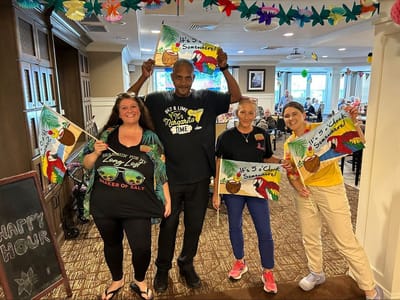 Staff and residents celebrating with colorful decorations