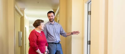 Staff member showing a resident their room