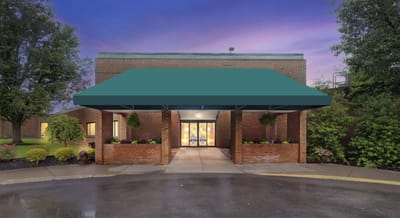Exterior view of the facility entrance with landscaping