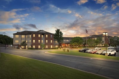 Exterior view of Town Village Tulsa at sunset