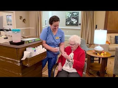 Staff assisting a resident in a common area