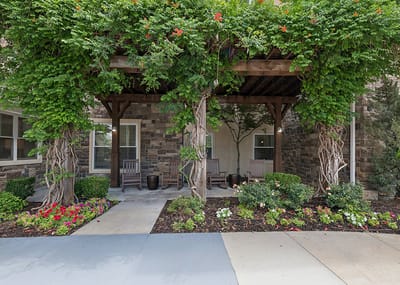 Exterior view of a shaded patio with flowers