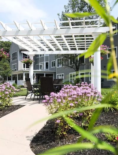 Outdoor seating area with flowers and building in background