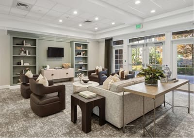 A cozy senior living common area with comfortable seating.