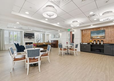 Bright common area with seating and piano