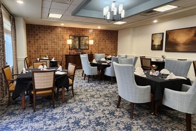 Dining area with tables and chairs set for meals