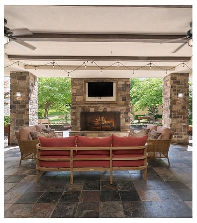 Outdoor lounge area with comfortable seating and fireplace