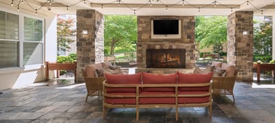 Outdoor lounge area with seating and fireplace