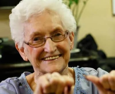 Smiling elderly woman in a social setting
