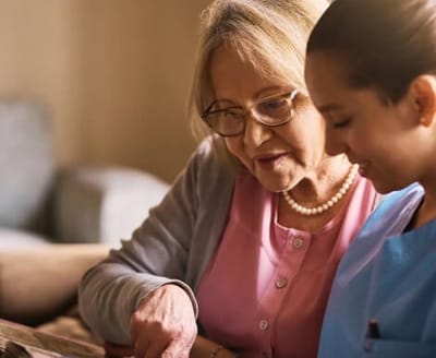 Staff member engaging with a resident in a cozy setting