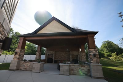 Covered outdoor area with seating and landscaping