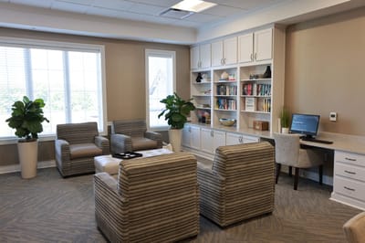 A cozy common area with seating and bookshelves