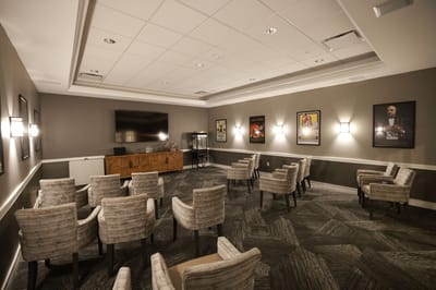 An activity room with chairs and framed artwork