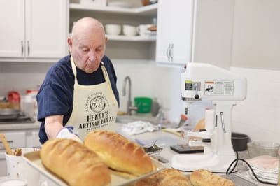 Resident baking bread in a facility kitchen