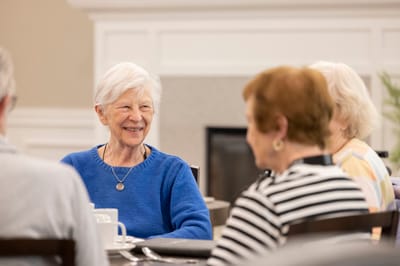 Residents enjoying conversation in a dining area