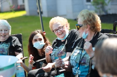 Residents and staff enjoying time outdoors together