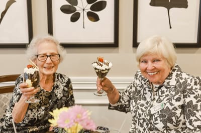 Two residents enjoying dessert together