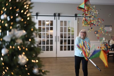 Resident enjoying a festive activity inside the facility