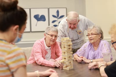 Residents engaging in a game of Jenga in a common area