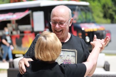 Residents enjoying a dance outdoors during an event