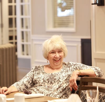 A smiling resident in an inviting common area
