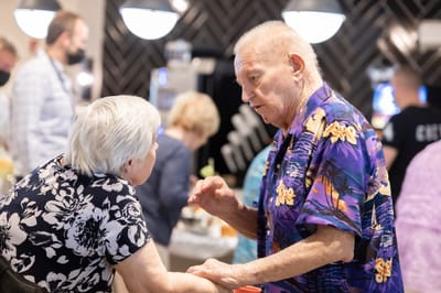 Residents engaged in conversation in a lively common area