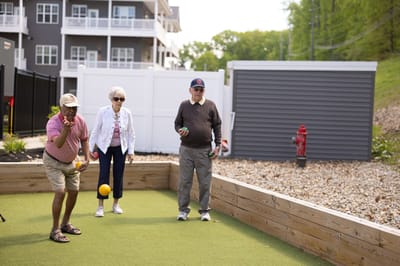 Residents playing bocce in an outdoor space