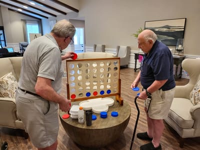 Two residents playing a game in a common area