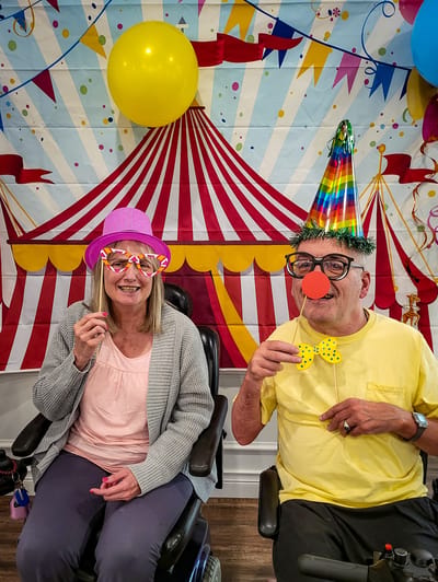 Residents enjoying a festive activity with props