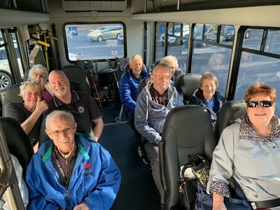 Residents enjoying a group outing on a transport bus