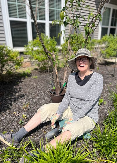 Resident enjoying gardening in a vibrant outdoor space