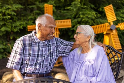 Two residents sharing a joyful moment outdoors