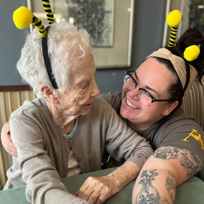 Staff member and resident enjoying a heartwarming moment together