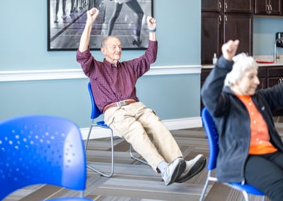 Residents participating in a seated exercise class